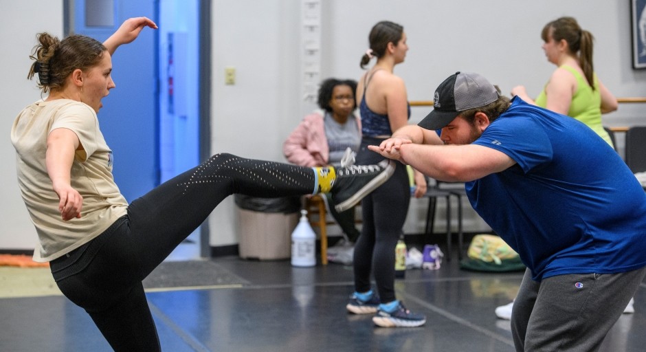 student kicking out at another in a practice fight move