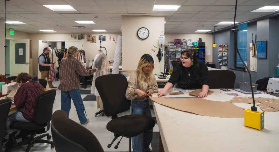 photo of costume shop with students and staff working at different stations