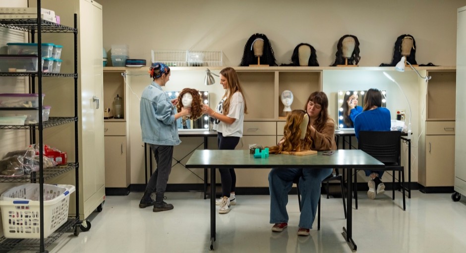 students working with wigs and make-up