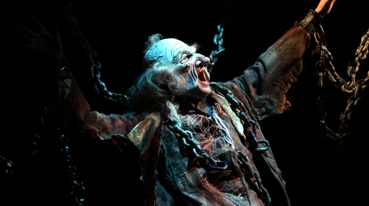 student with a mask and elaborate costume for the play Christmas Carol