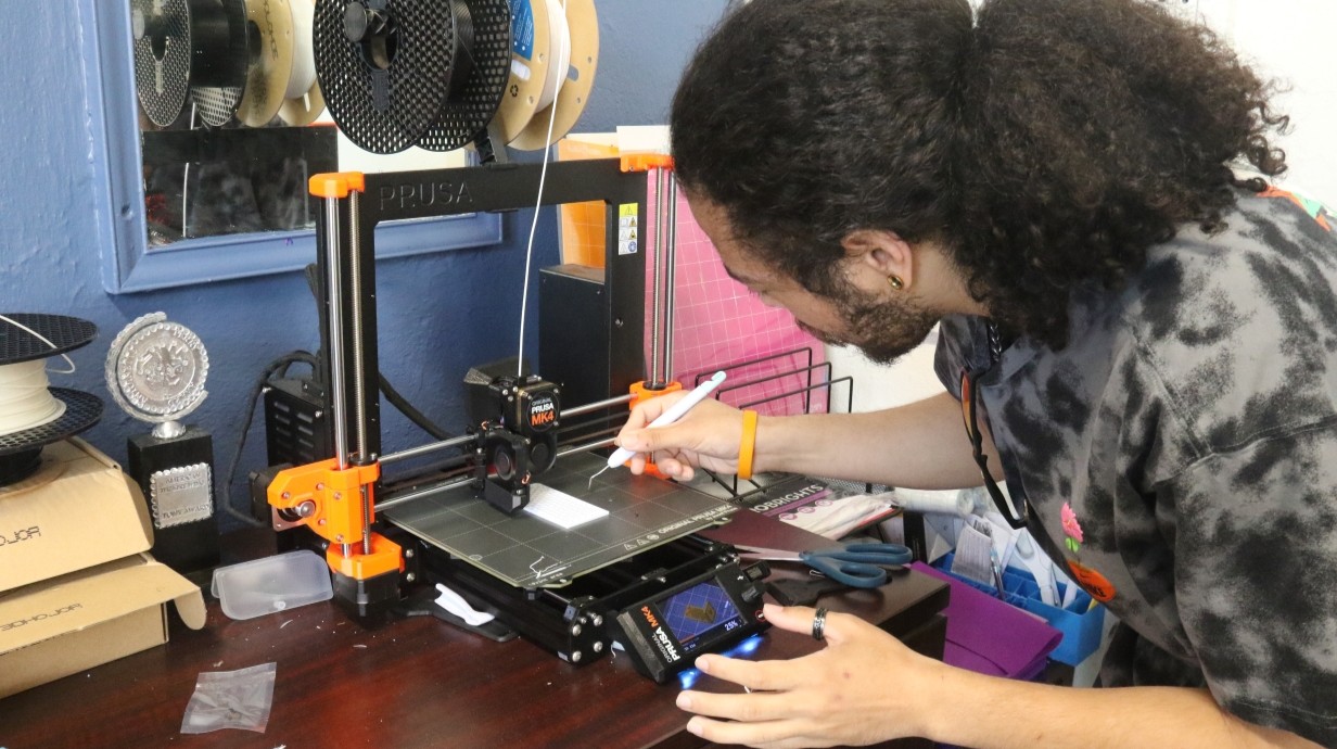 student working with a 3-D printer