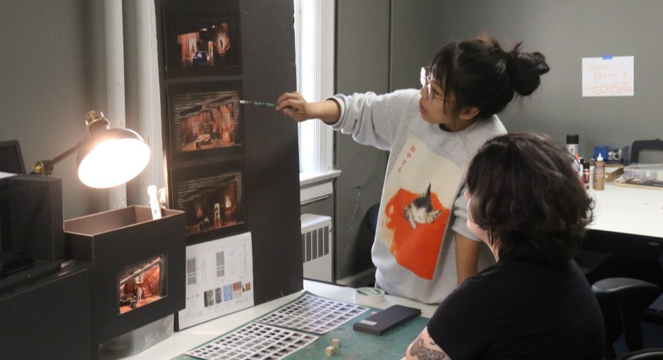 image of a student and faculty member working together at a design board