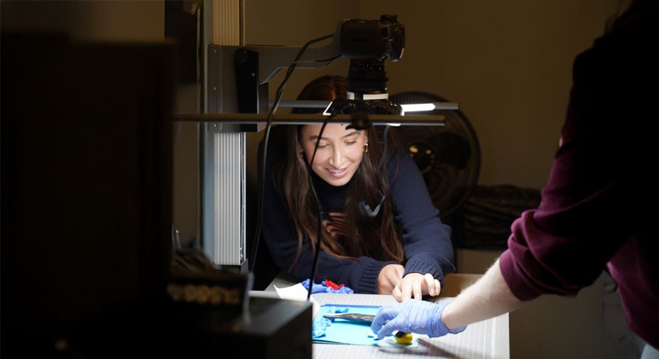 image of a student smiling while she works at an animation table and camera