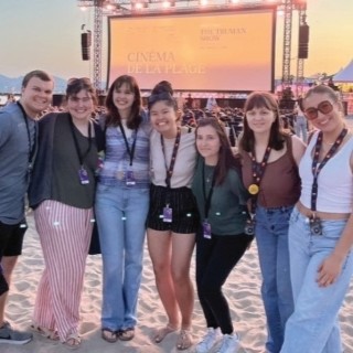 image of a small group of students standing together on a beach at Cannes Film Festival