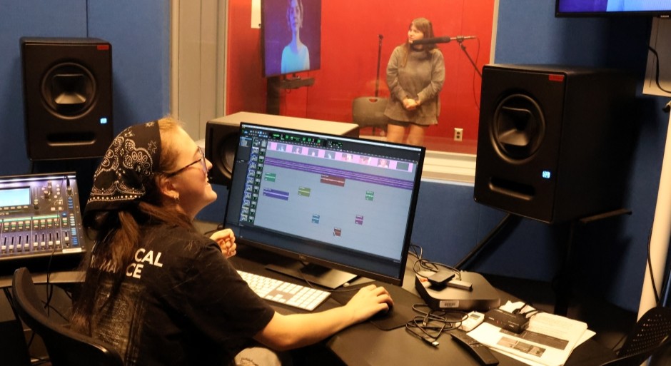 student is a control room and in a recording studio