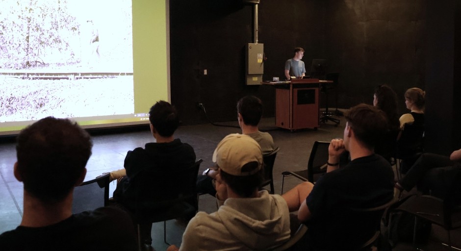 image of a student making a presentation in front of a small group