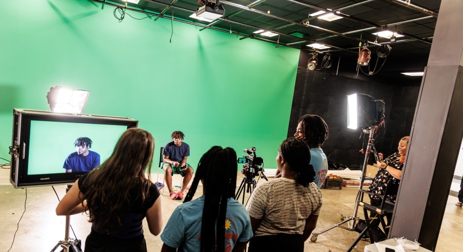 students working with camera equipment in a sound stage