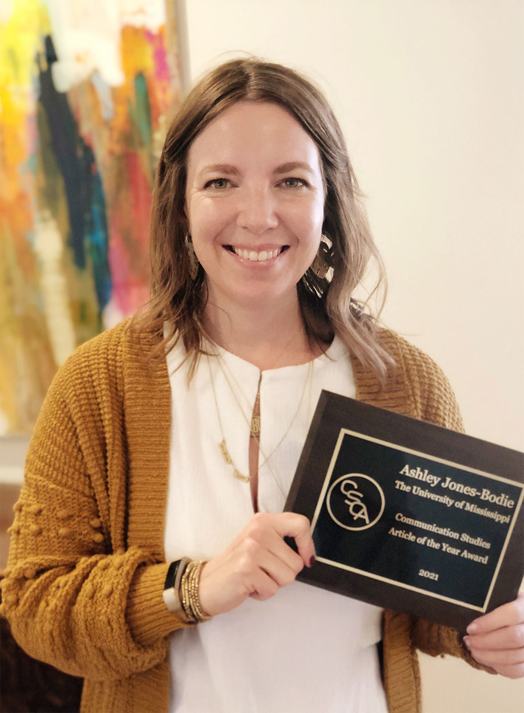 woman holding plaque award