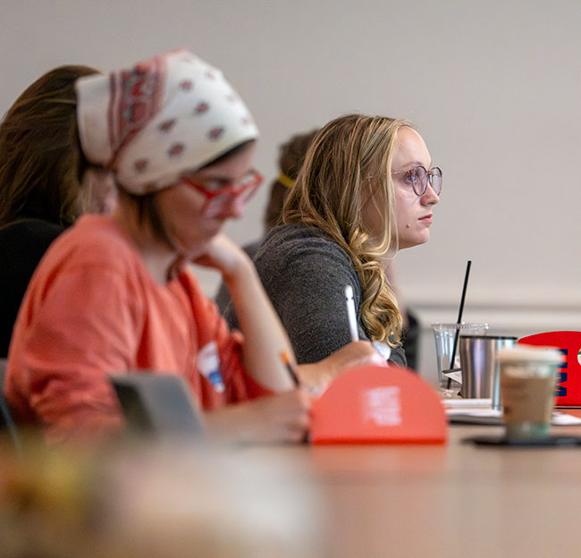 students writing in class at desk