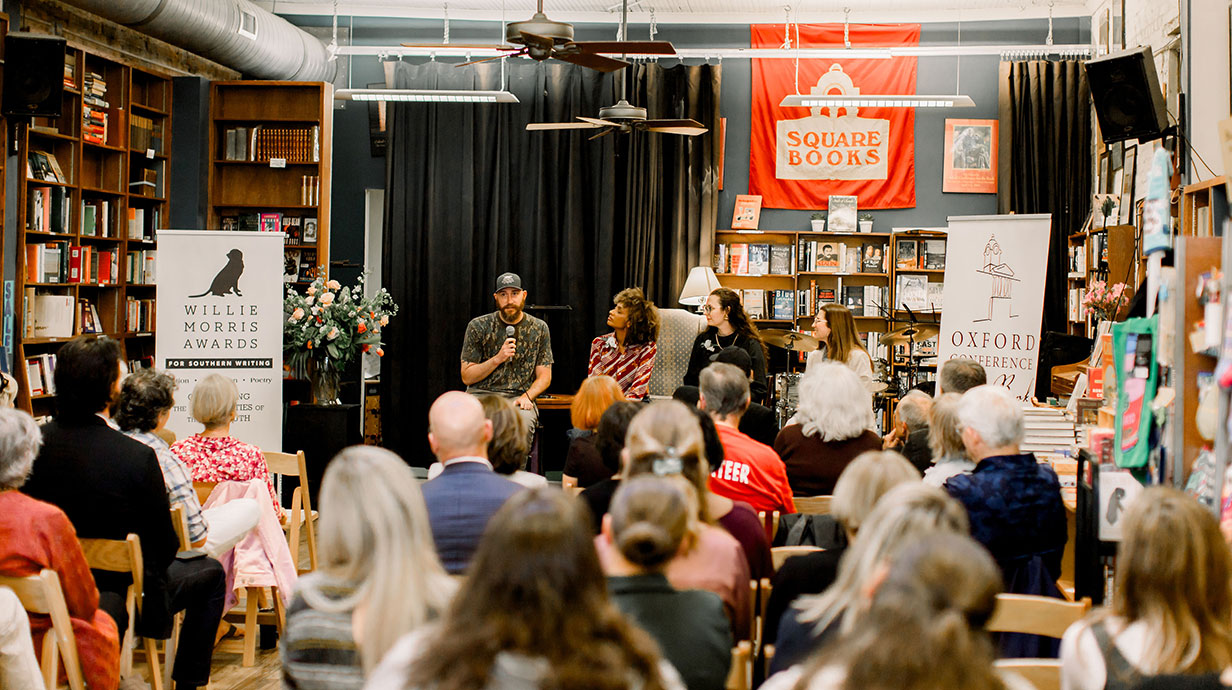 people giving a talk in a book store