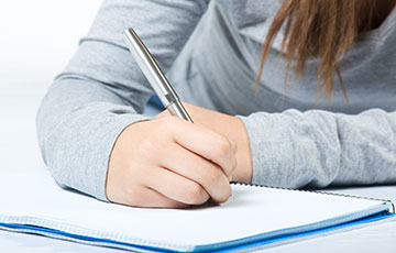 woman writing on paper