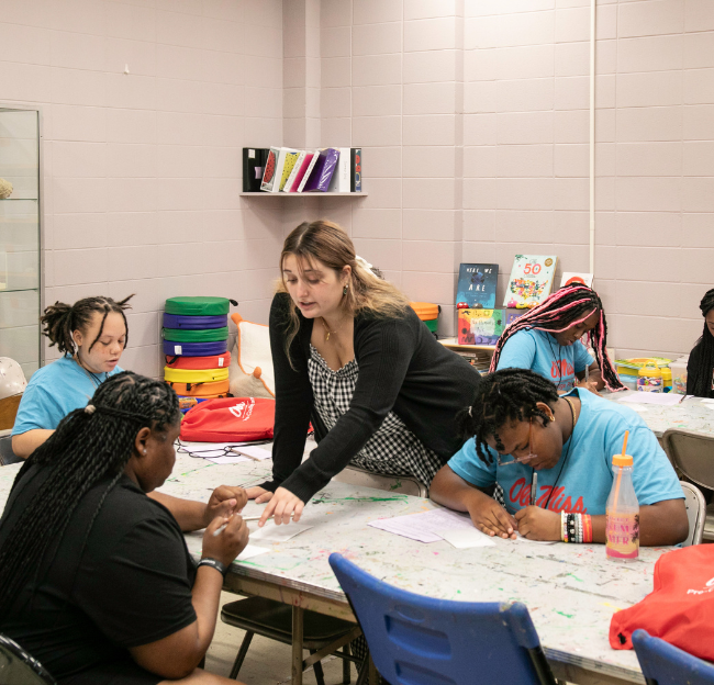 Photo of a faculty members interacting with a Good Life participant.