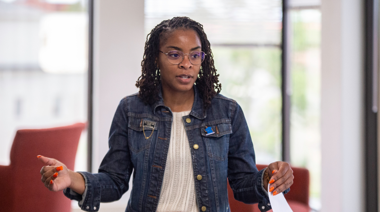 Staff member interacting with student participants.