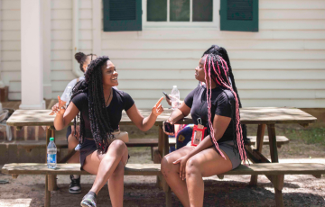 Two student participants talking to one another.