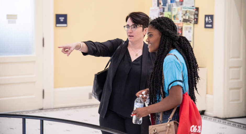 Faculty member talking to a student participant.