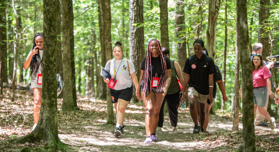 Student participants walking to Rowan Oak.