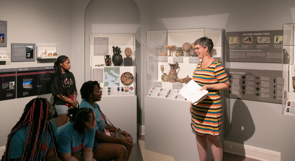 Student participants receiving a tour at the University Museum.