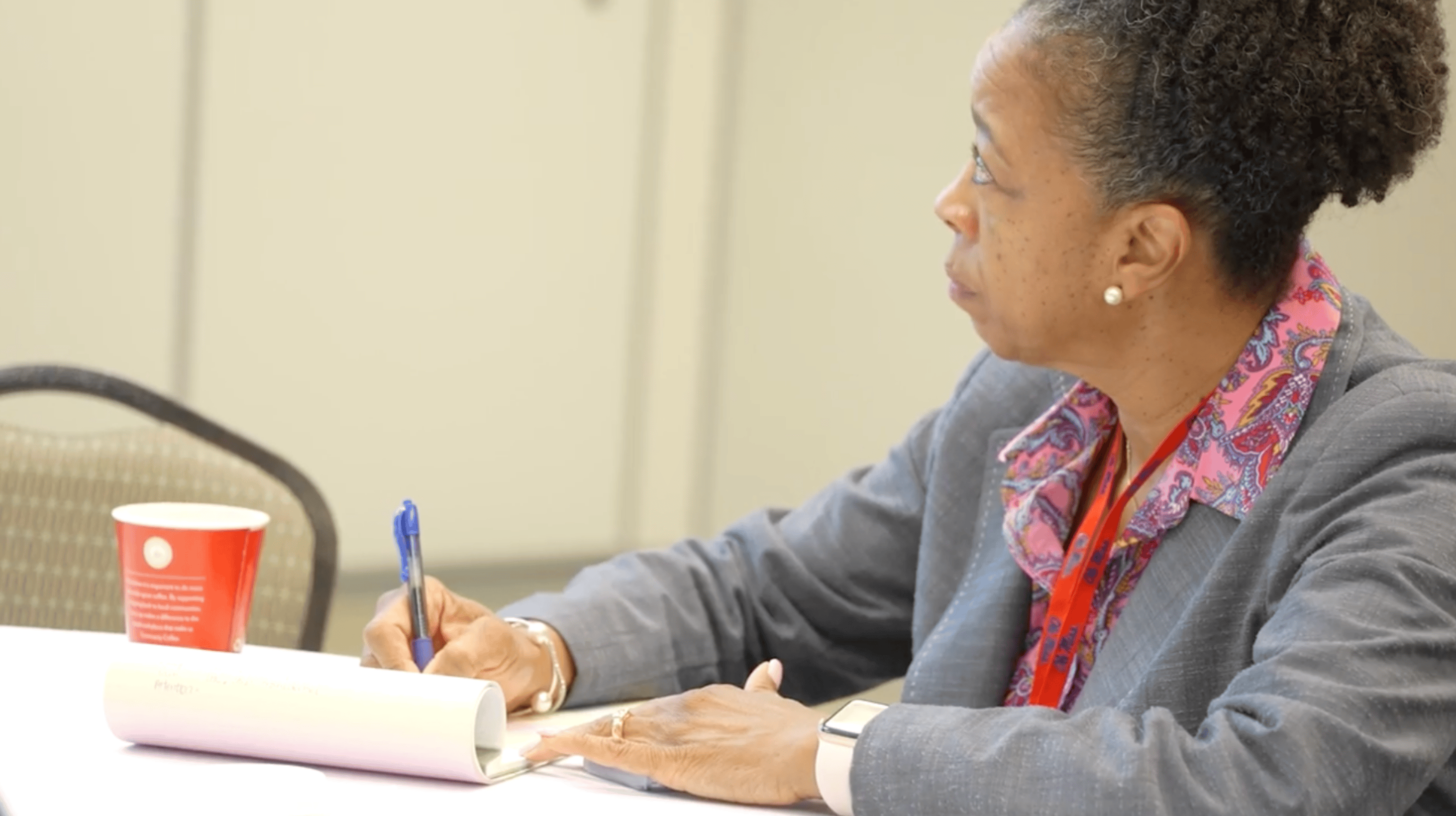 Healthcare provider makes notes at continuing education conference