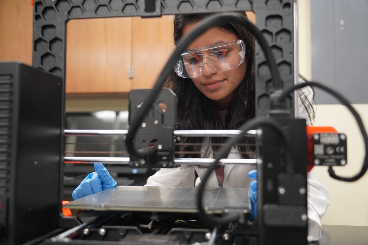 student watching a 3D printer