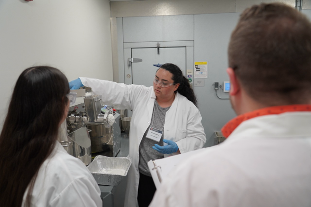 Scientist showing how to use a machine.