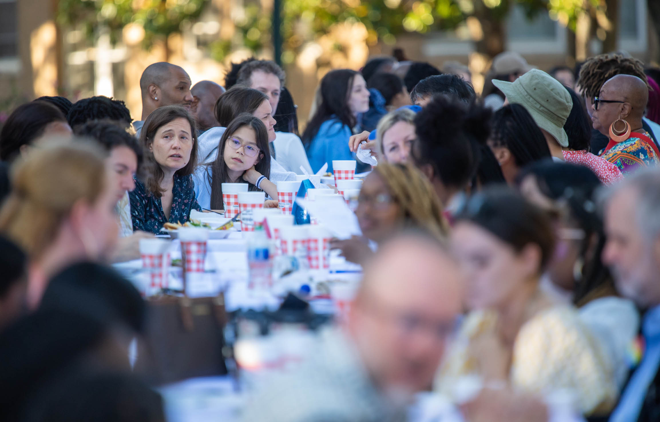 a group of people sitting at a table outdoors