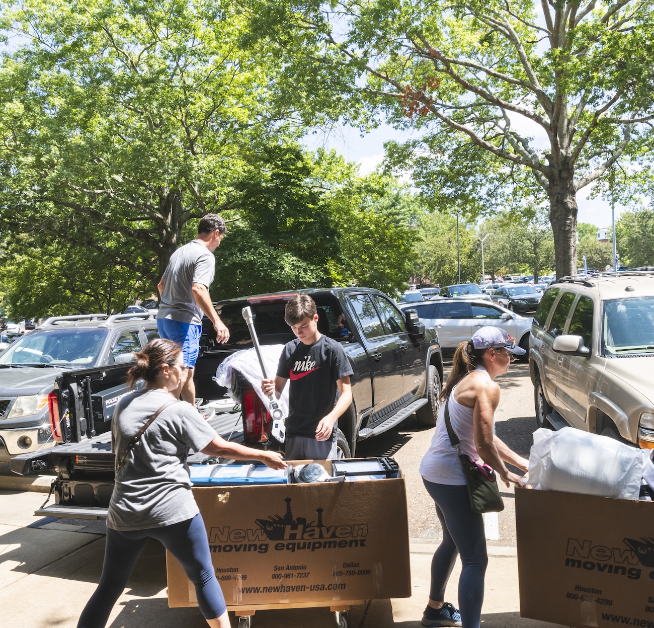 Two students load a car