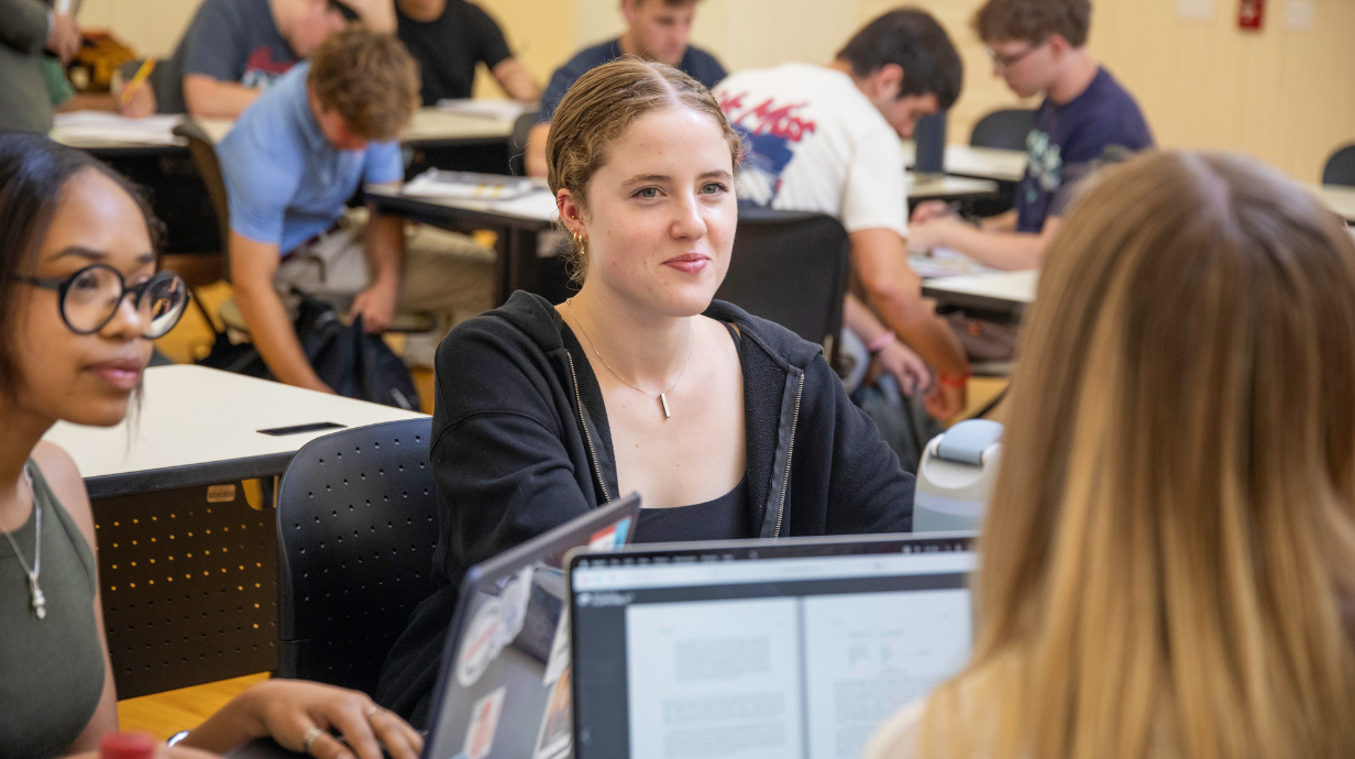 Students in a room having a discussion 
