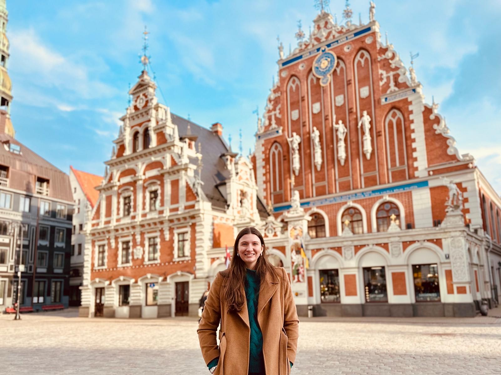 Student stands in front of cultural building
