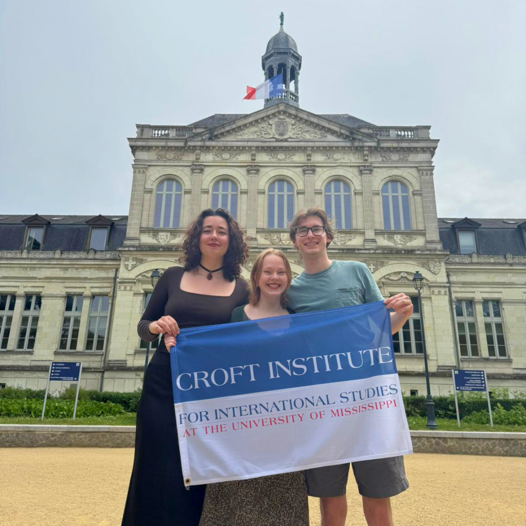 Students holding up Croft flag abroad
