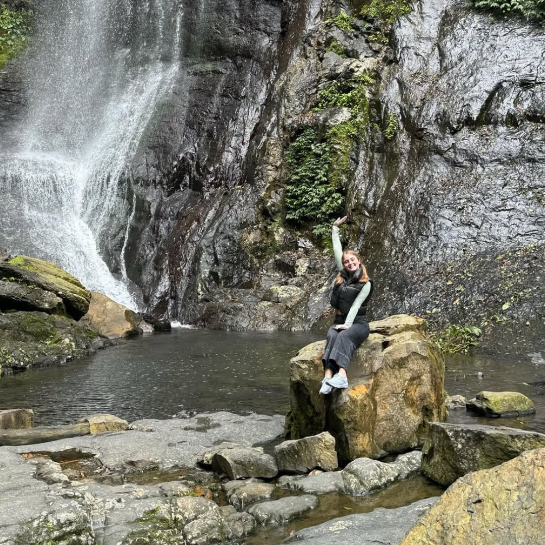 Croft student sitting by Jiao Xi waterfall