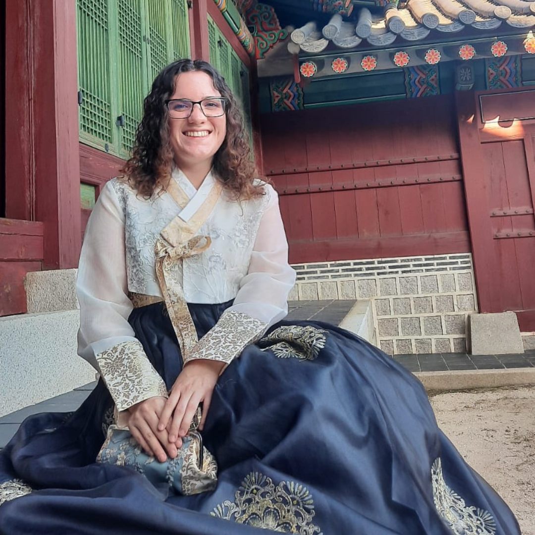 Croft student sitting on steps of Korean temple