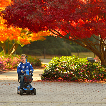 A student uses his wheelchair to get to class