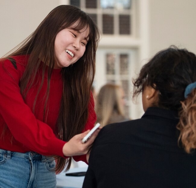 International Student laughs with another person