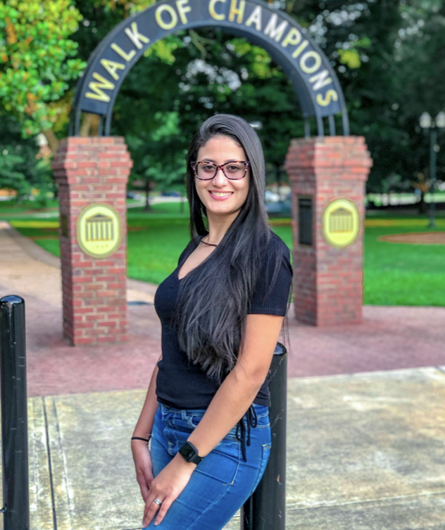 female international student poses in front of walk of champions