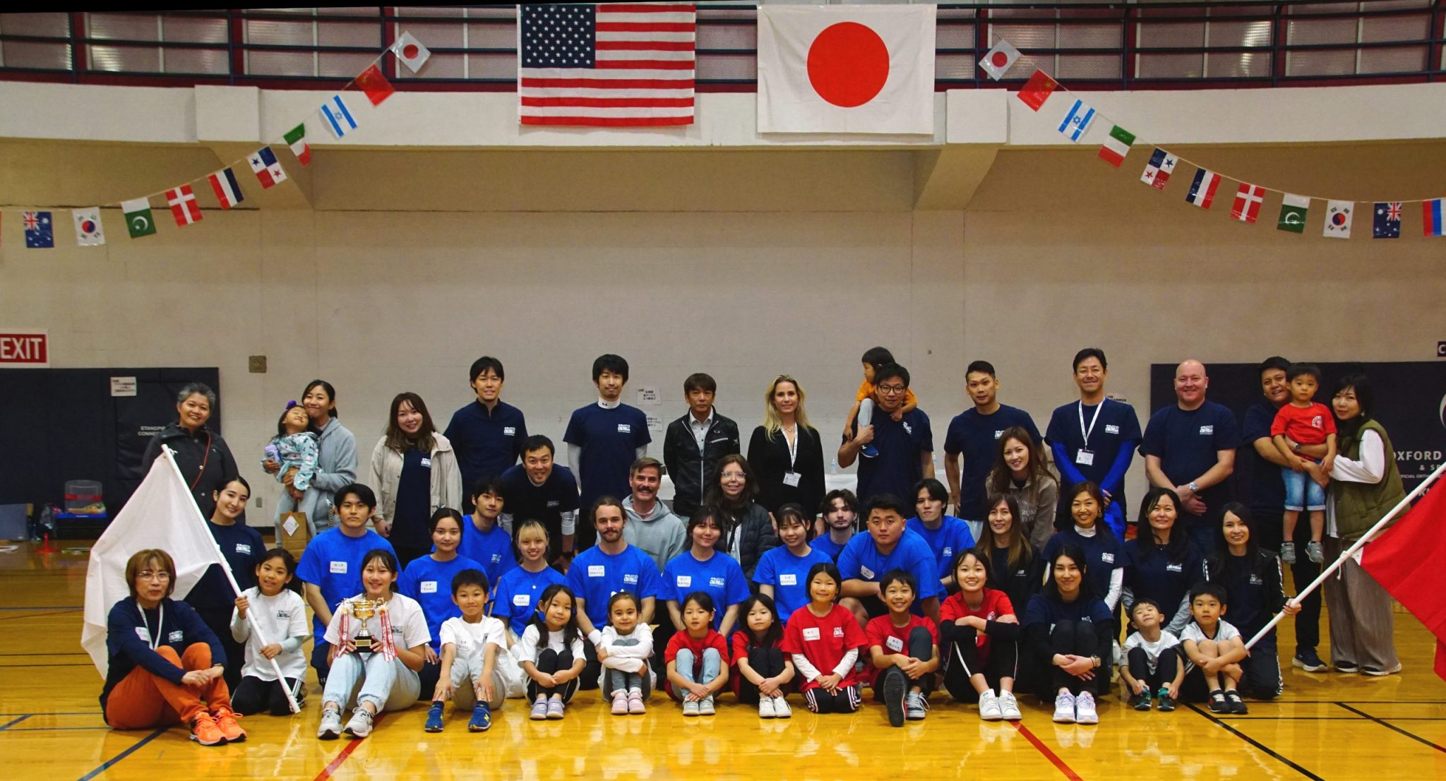 a group of children and USJP members pose for a group picture