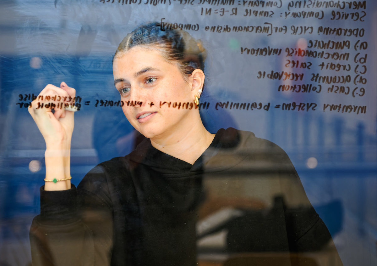 Student Writing on Glass 