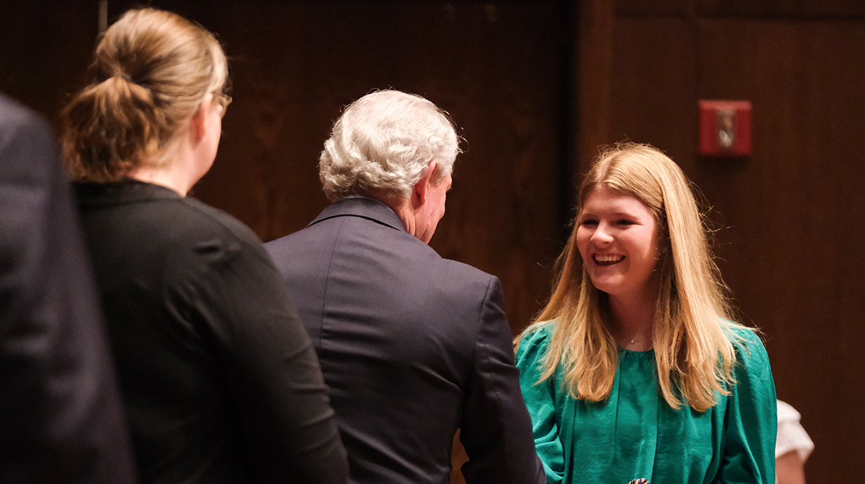 Woman receiving Phi Kappa Phi cords
