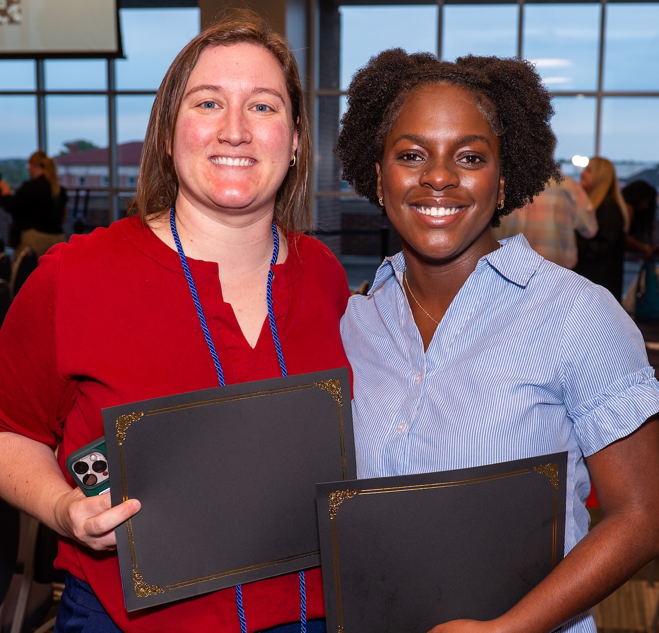 Two first-gen alumnae pose.