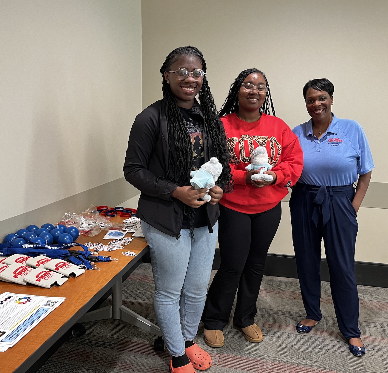 Students pick up wellness tabling materials. 