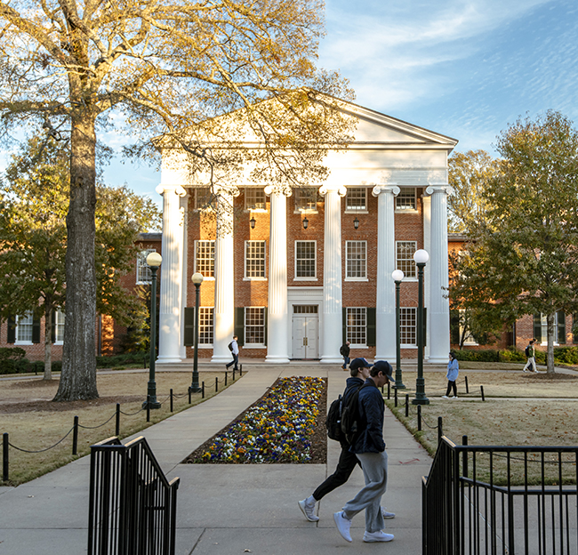 The Lyceum on a sunny day with students walking on the sidewalk