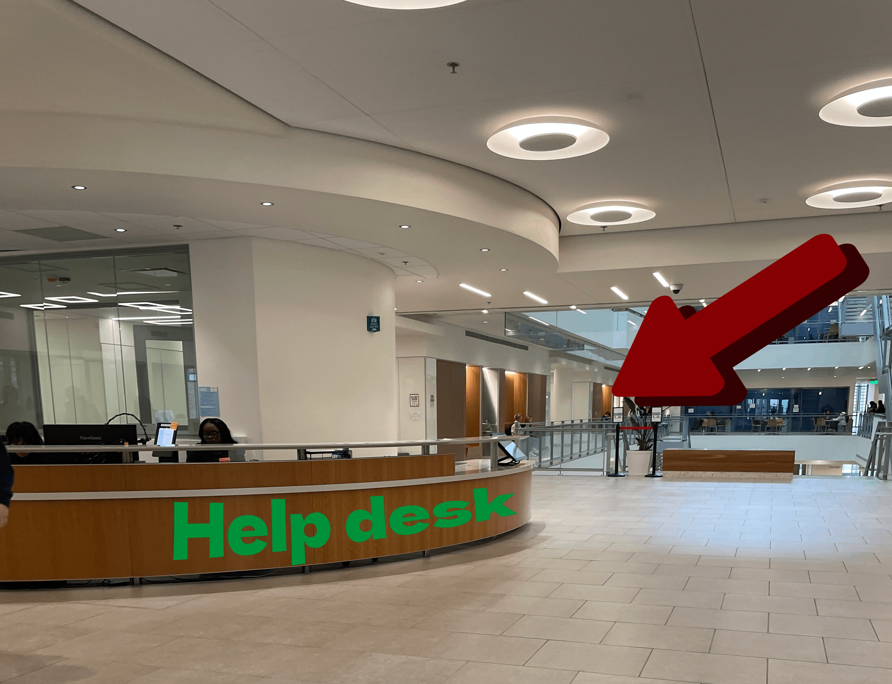 showing the help/info desk on floor 2 where someone sits behid the counter