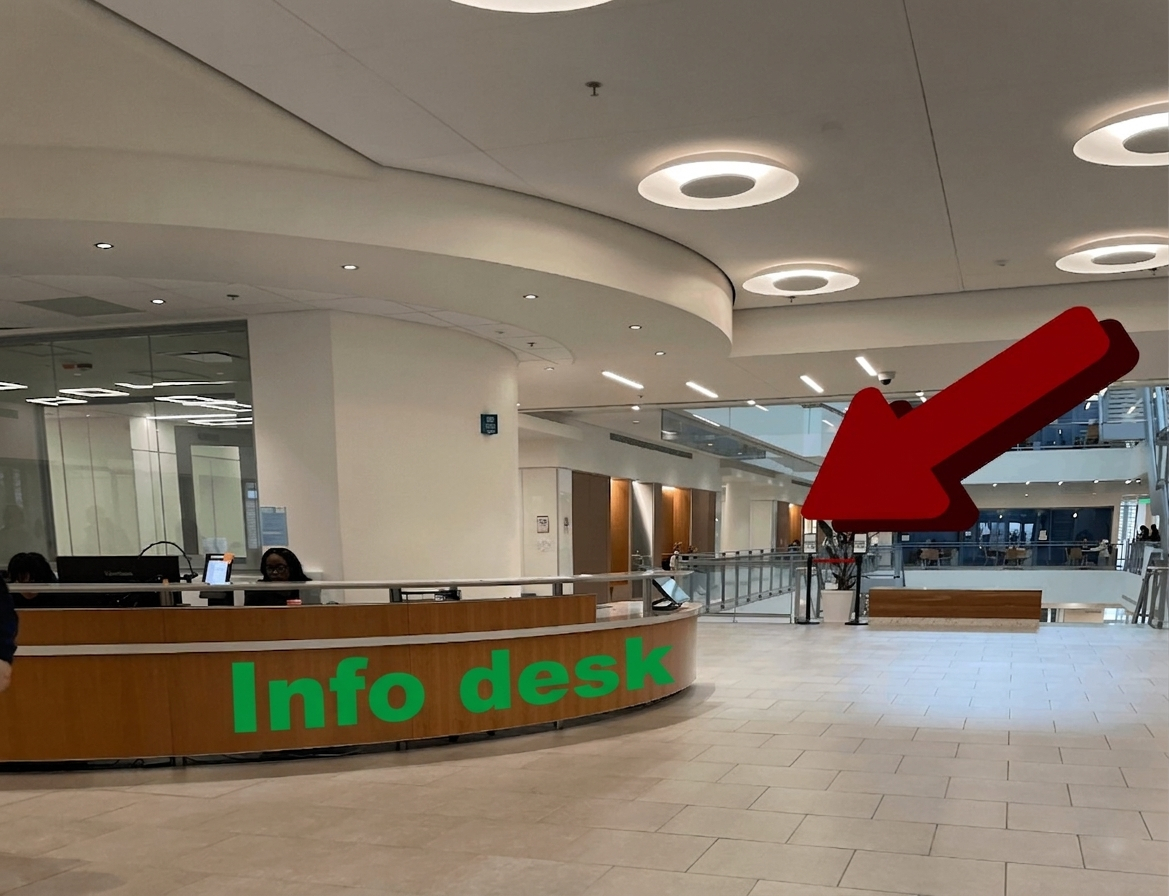 showing the help/info desk on floor 2 where someone sits behind the counter