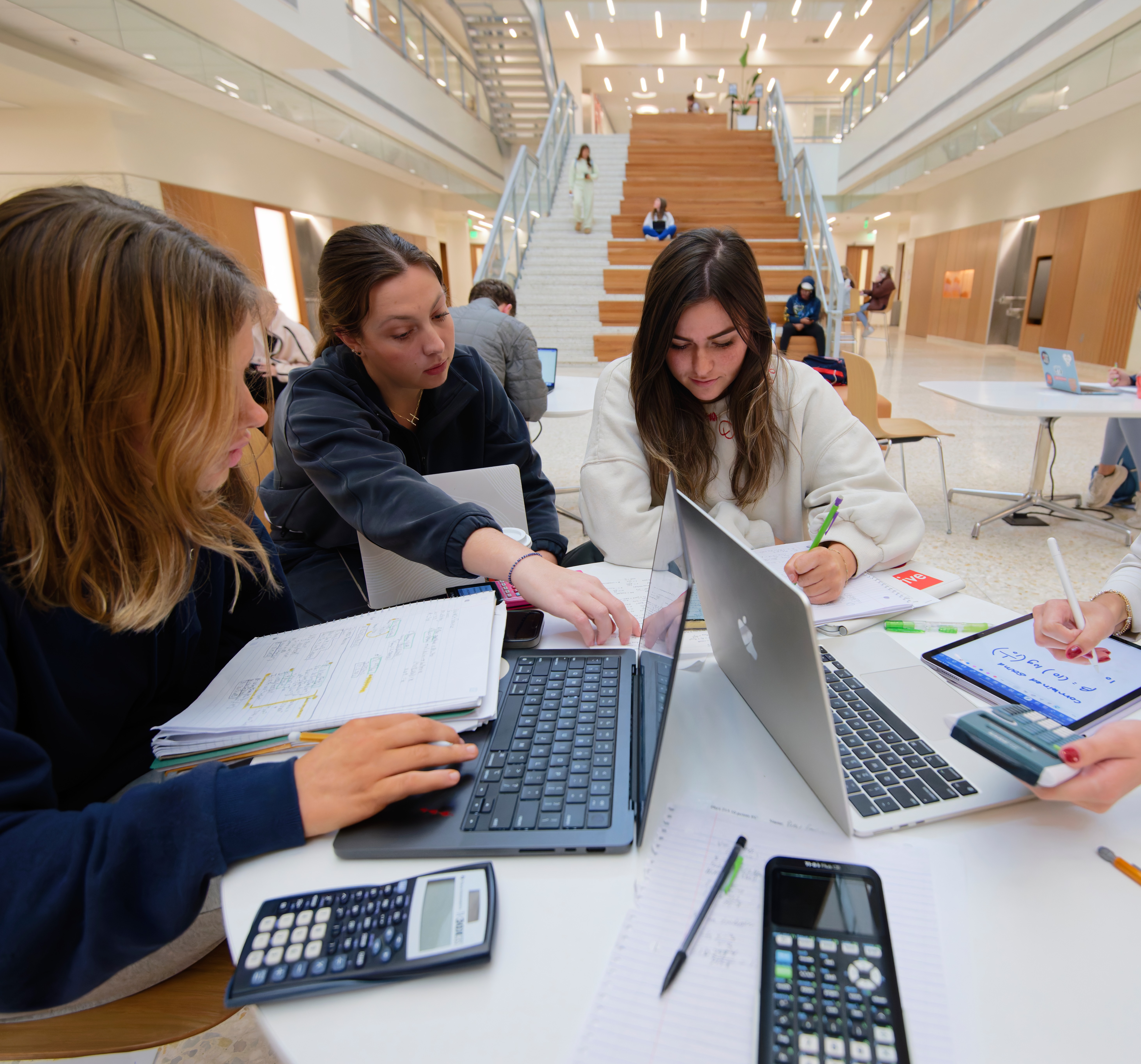 3 girls working in the duff-center lobby on a group project