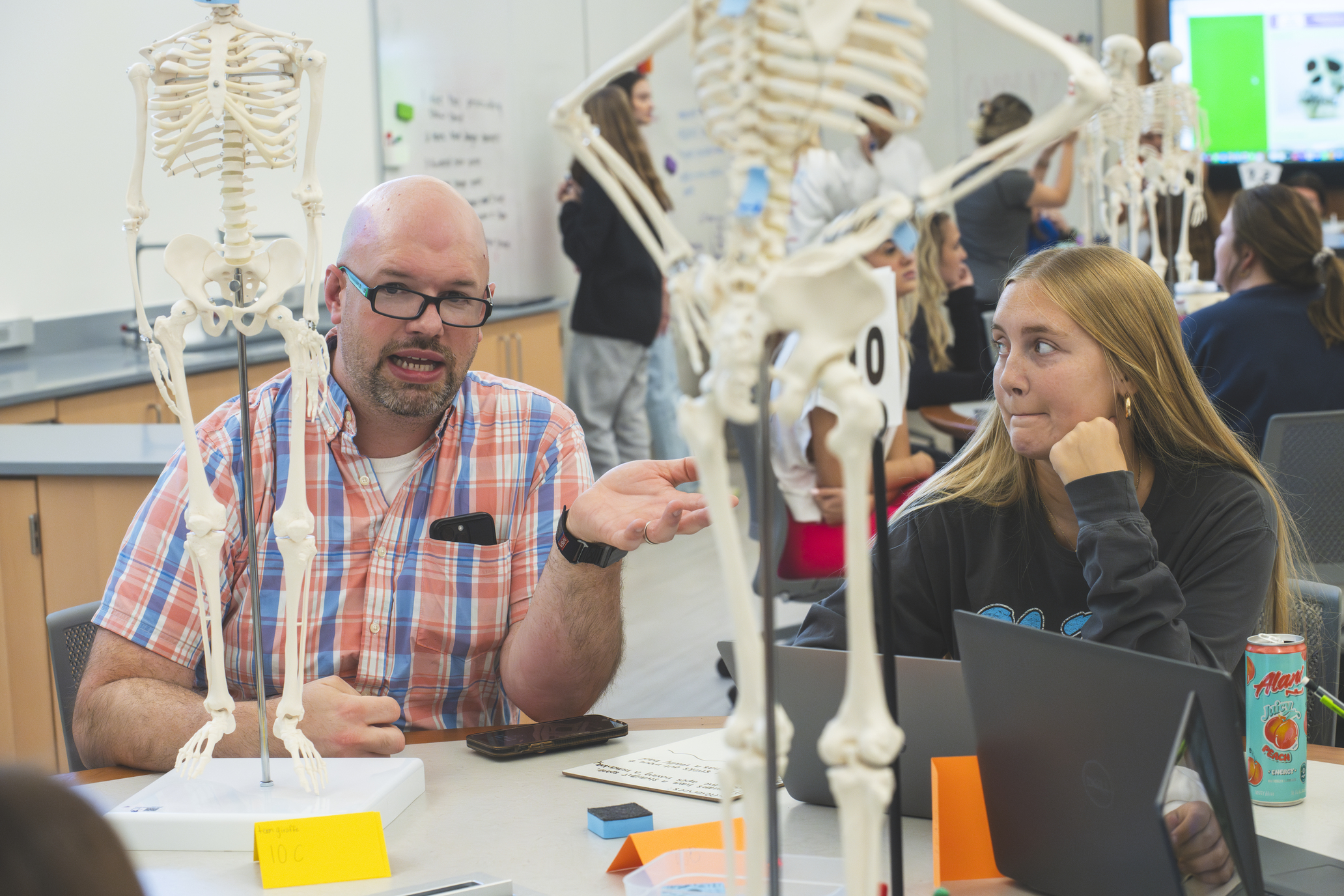 teacher explaining something to a student in a one on one talk
