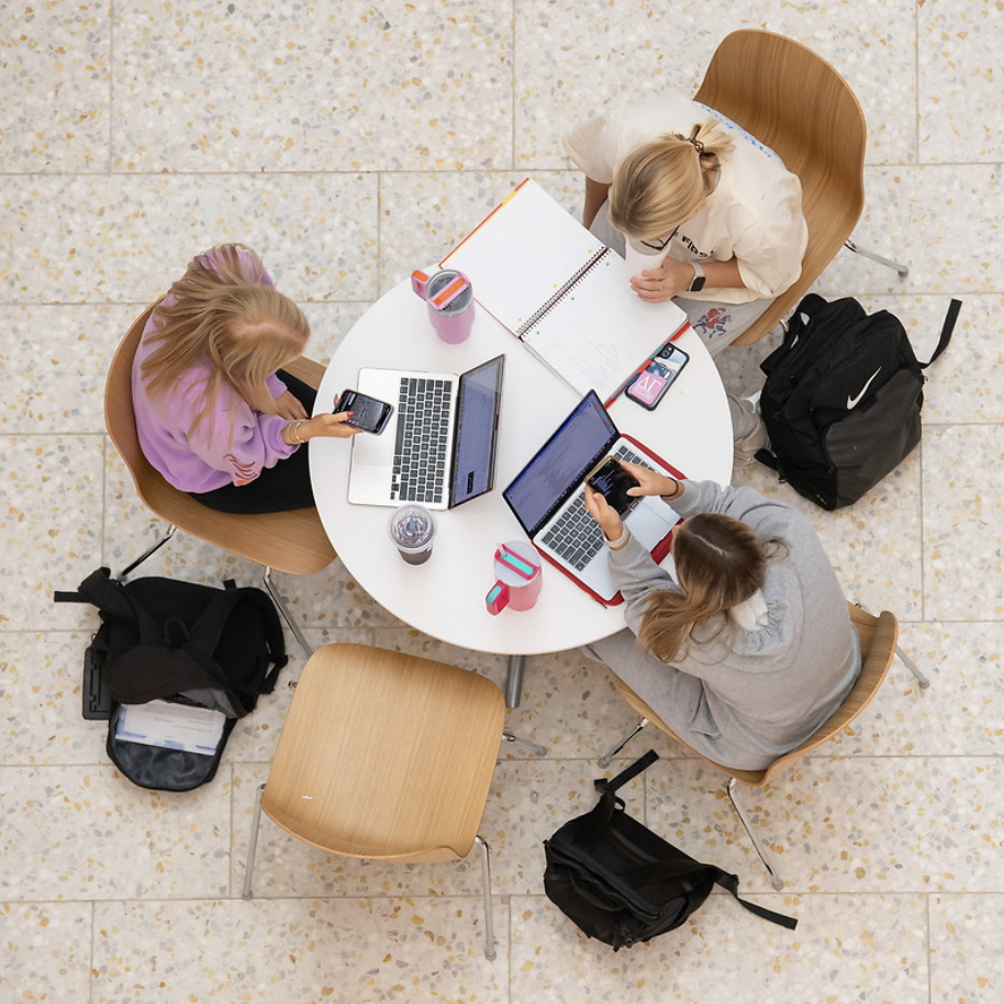 3 girls working in the duff-center lobby on a group project