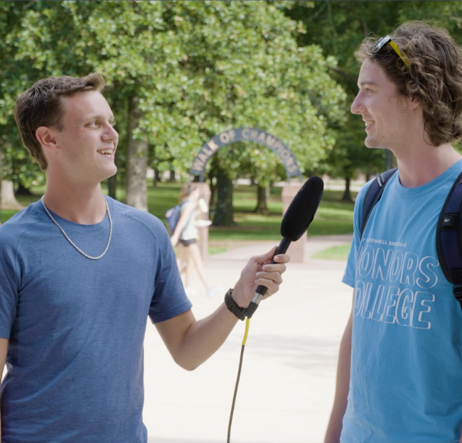 Two student researchers talking during an interview.