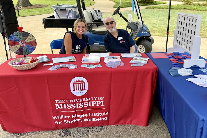 Volunteers pose at a tabling event.