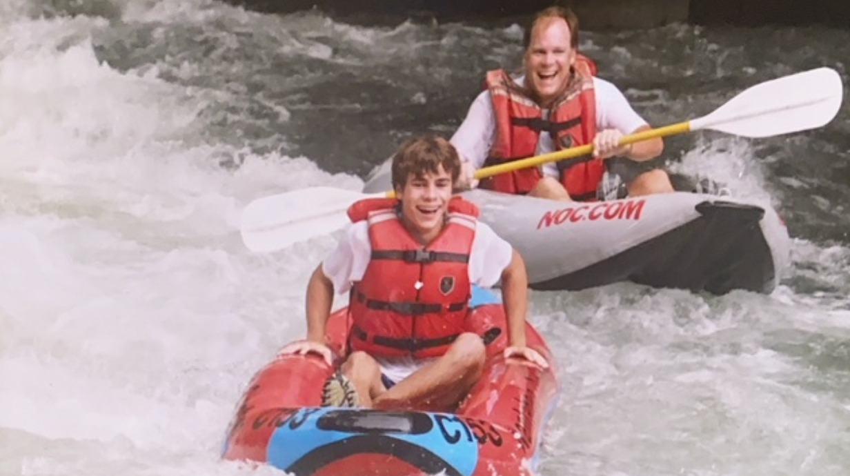 Dad and son water rafting