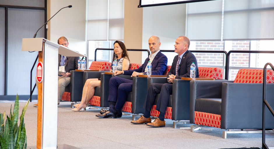 Four people on stage during a panel discussion.