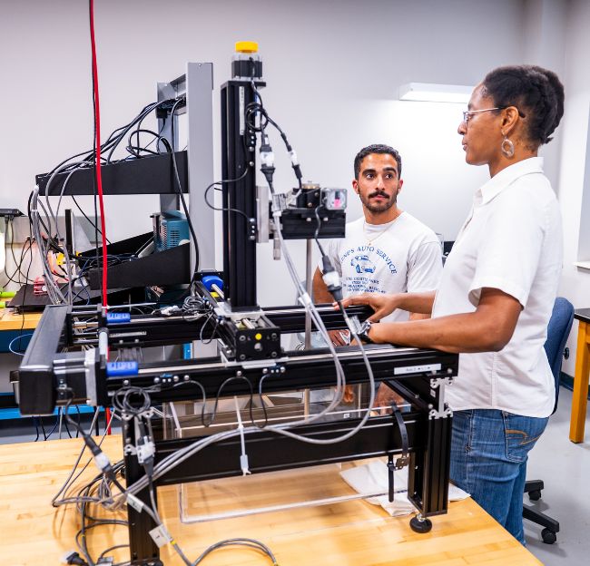 Two researchers working in an acoustics lab.